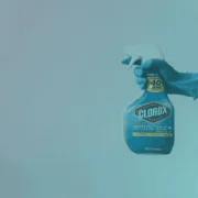 A hand holding a Clorox spray bottle
