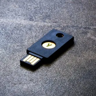 A YubiKey pictured lying on a flat surface